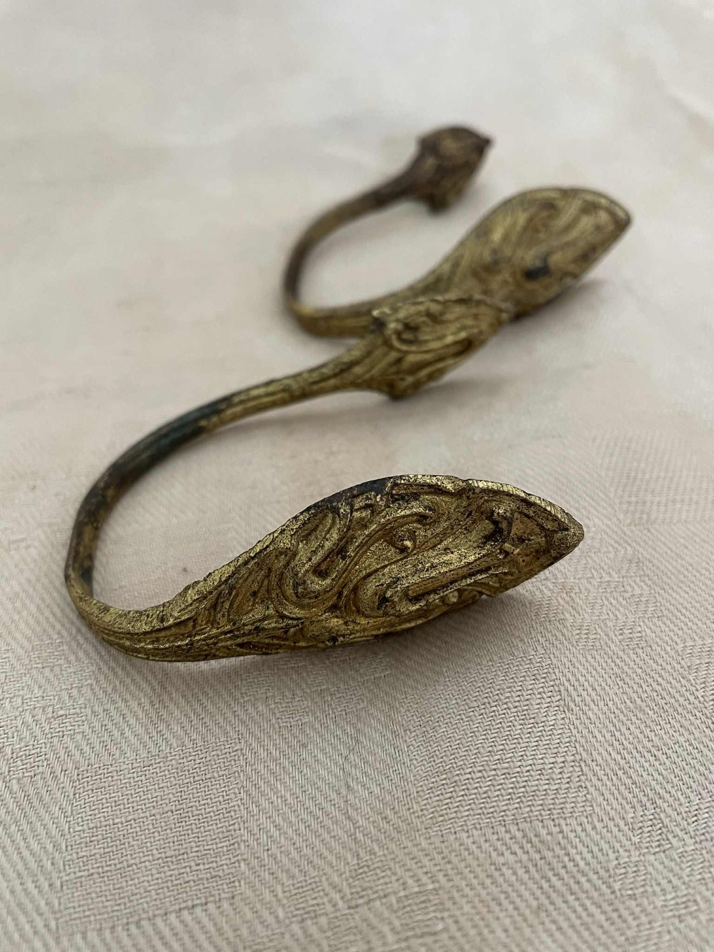 A pair of gilded brass curtain tie back hooks