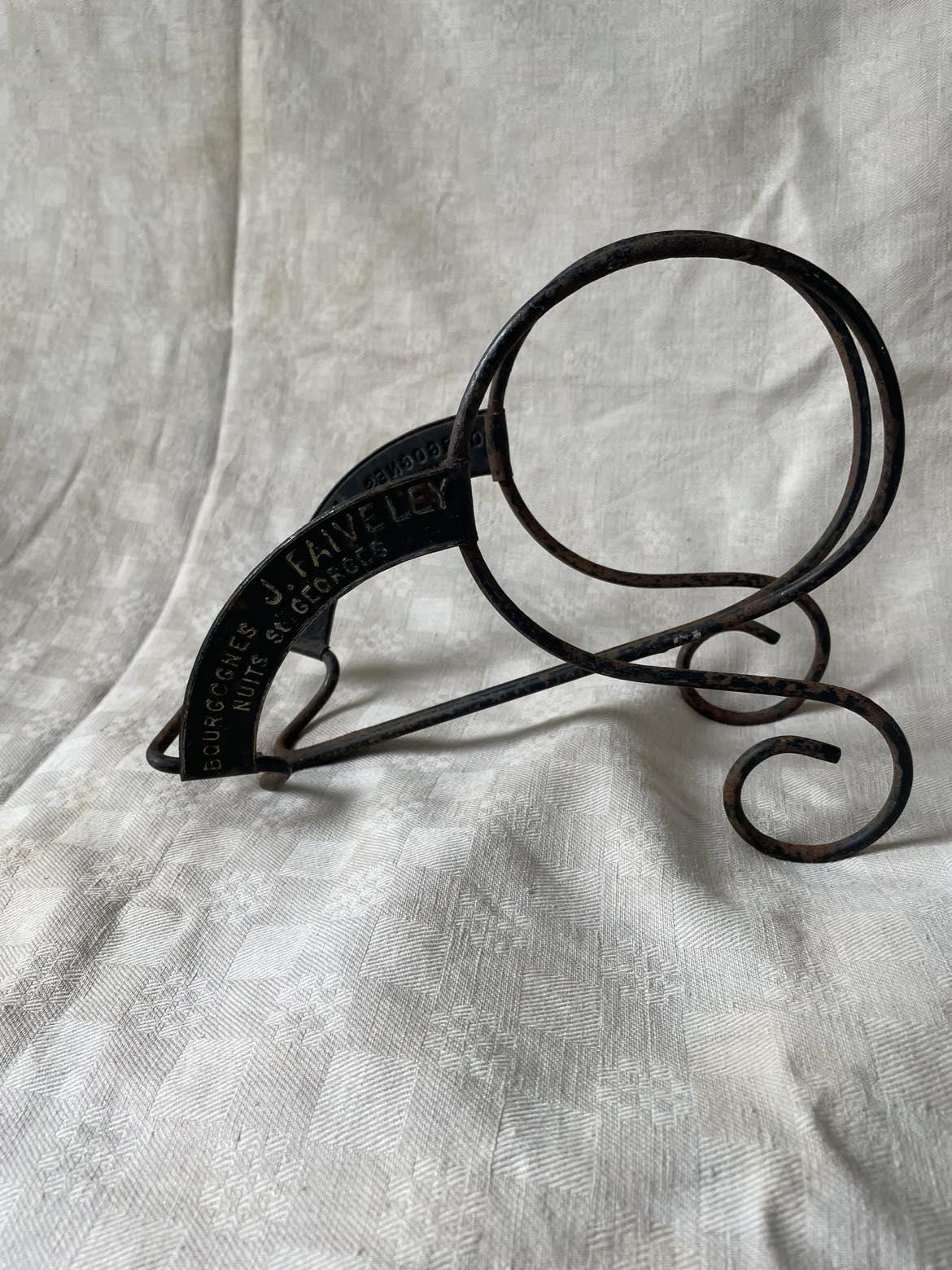 Vintage publicity bottle rest for Bourgognes (Burgundy wine) produced by Faiveley