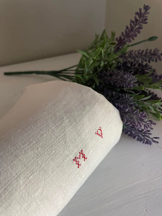 A single large plain Metis ( linen/cotton mix) tea towel initalled MV 100 x 52 cm