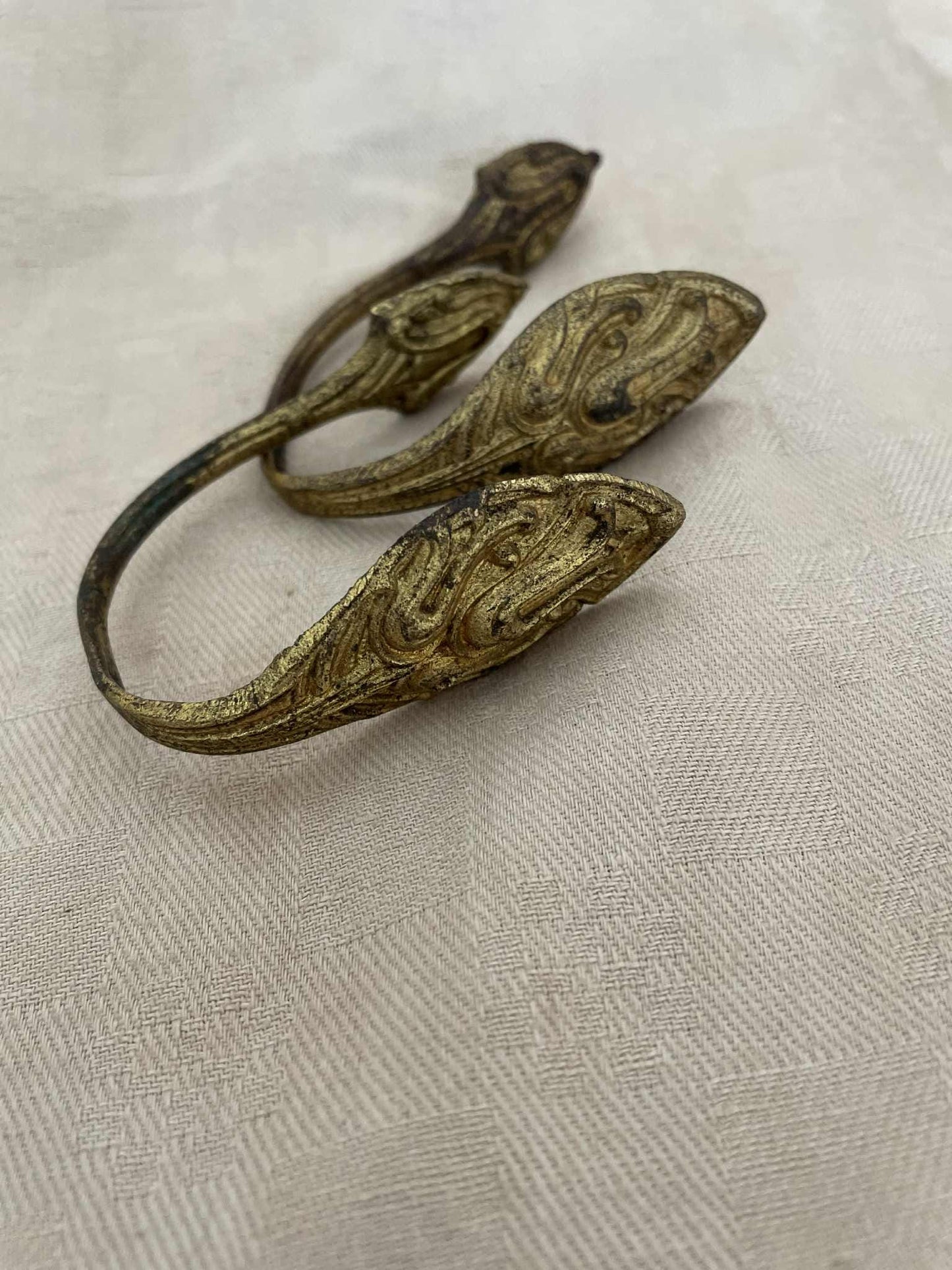 A pair of gilded brass curtain tie back hooks