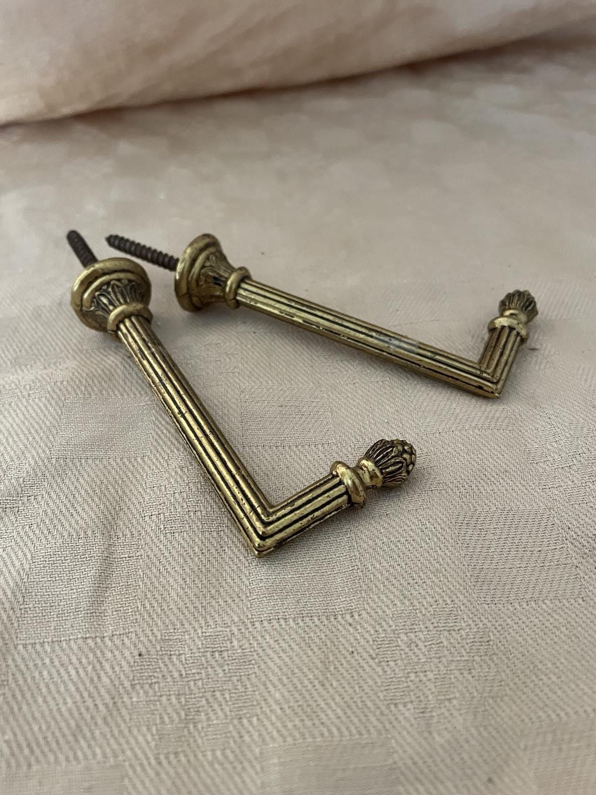 A Pair of brass curtain tie back hooks. - 10cm