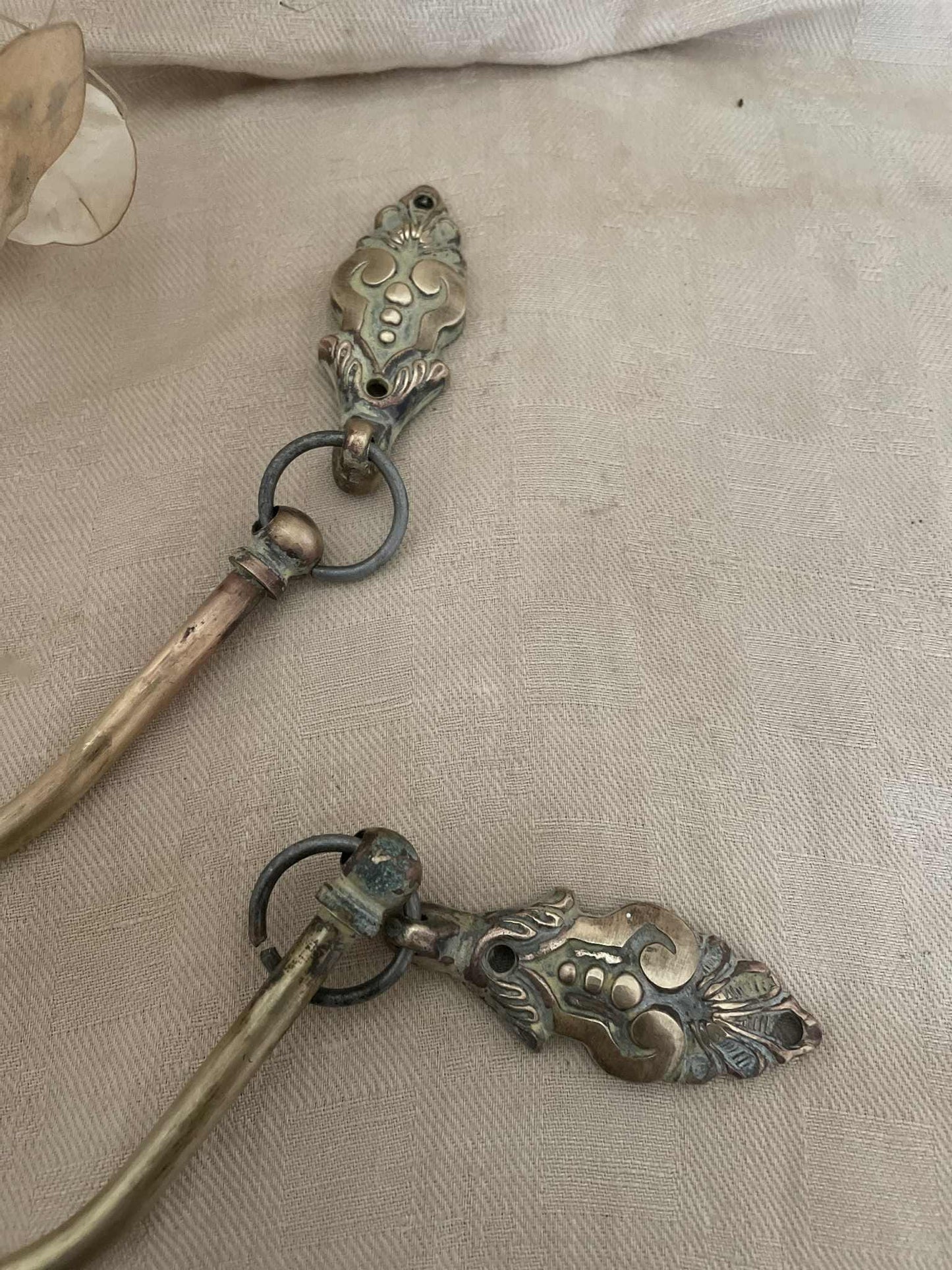 One pair of brass suspended swan neck curtain tie backs / embrasse rideau