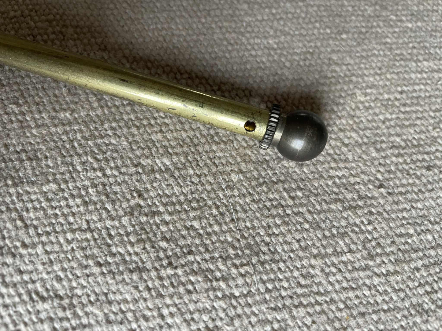 A single extendable brass lightweight curtain rod 58cm to 80cm max 7mm diameter