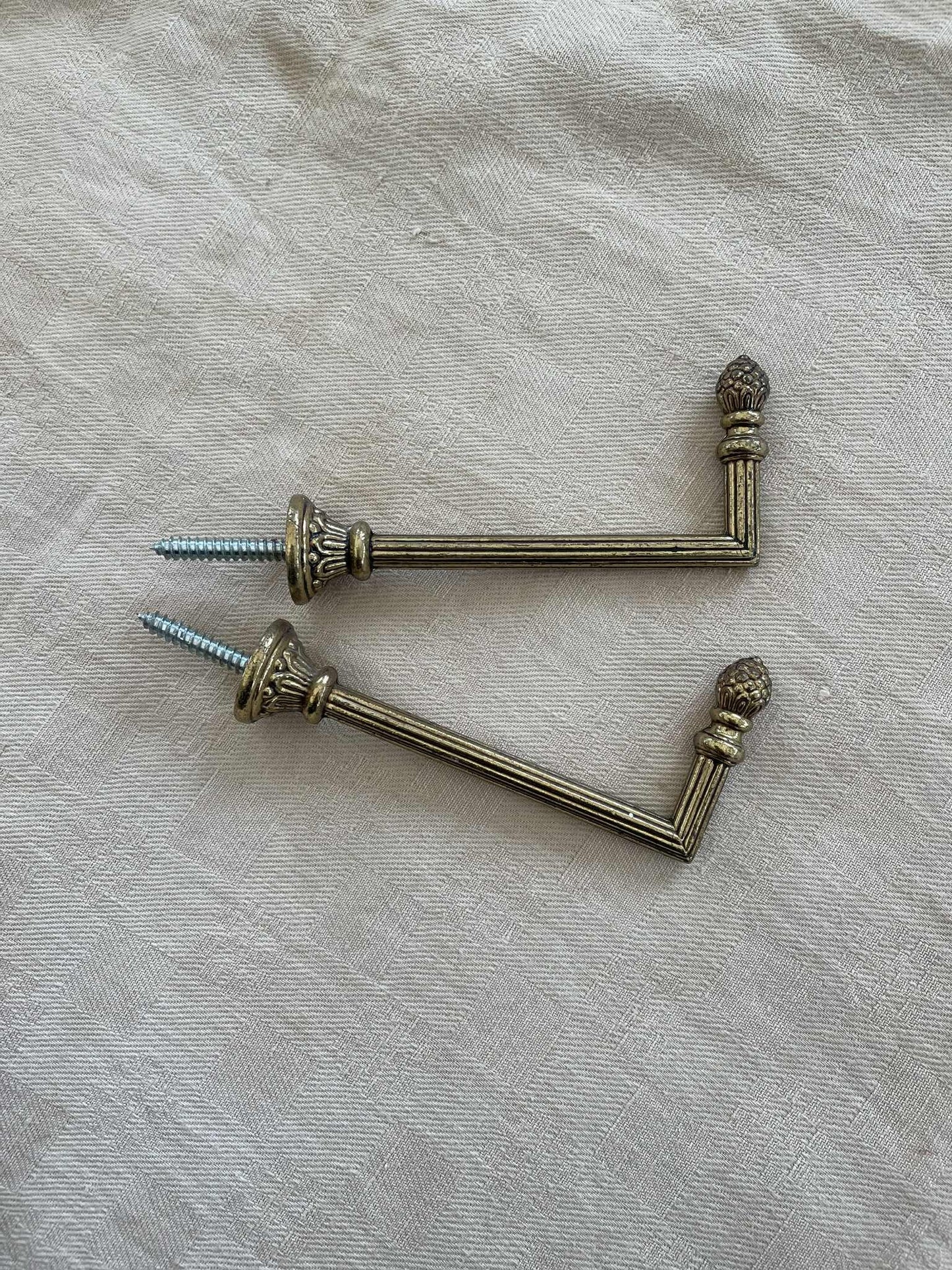 A Pair of brass curtain tie back hooks. - 10cm