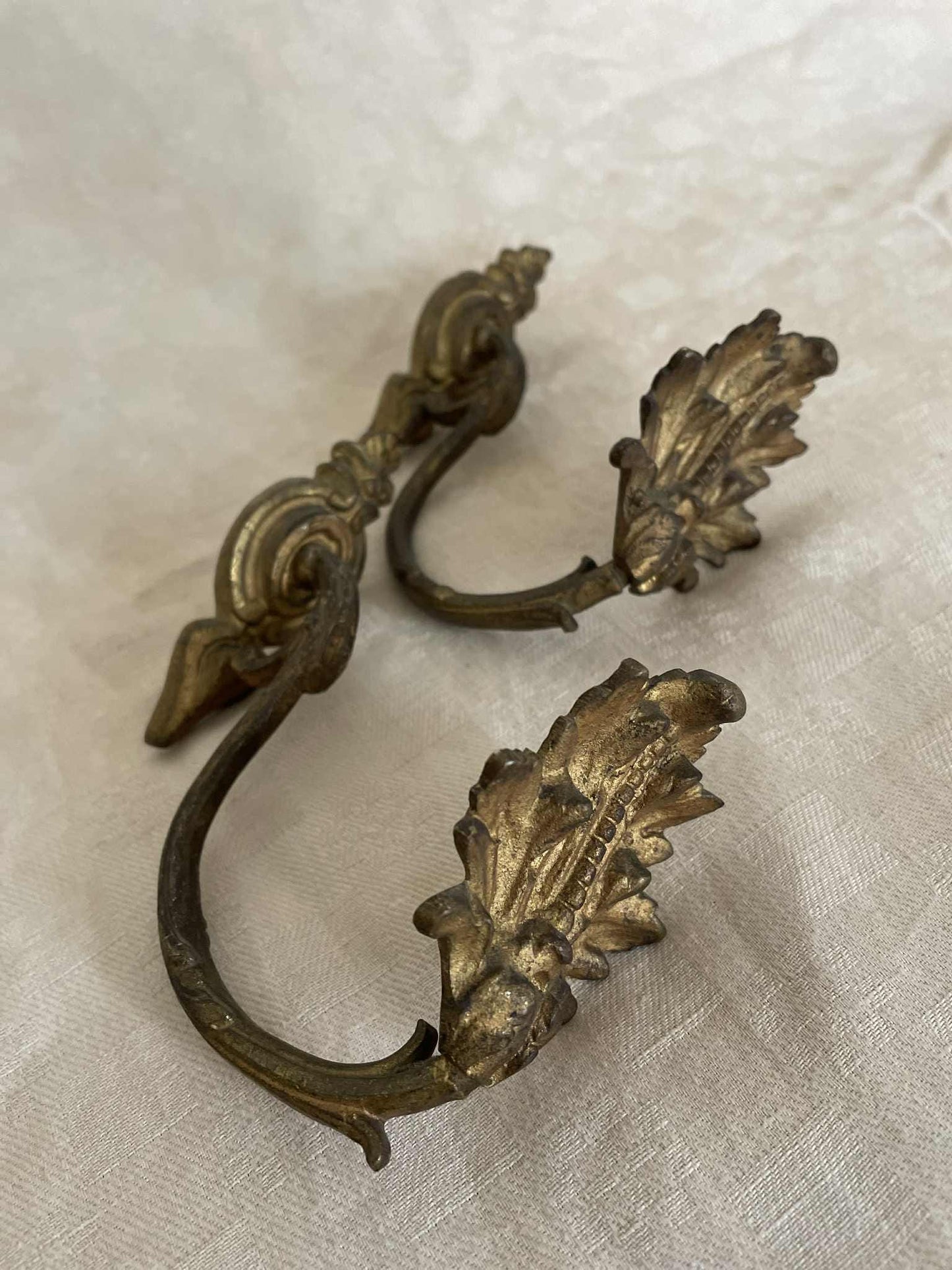 A pair of French gilded bronze curtain tie back/ wall hooks