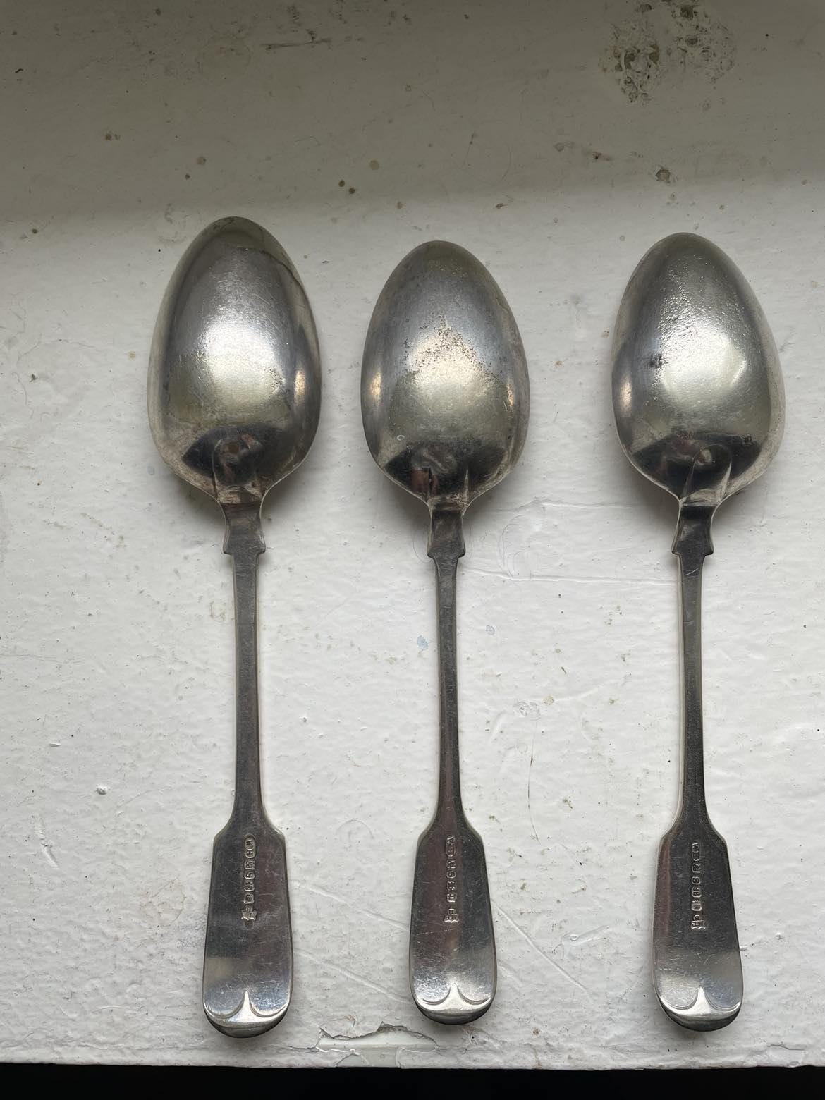 A set of 3 Monogrammed Silver plated spoons