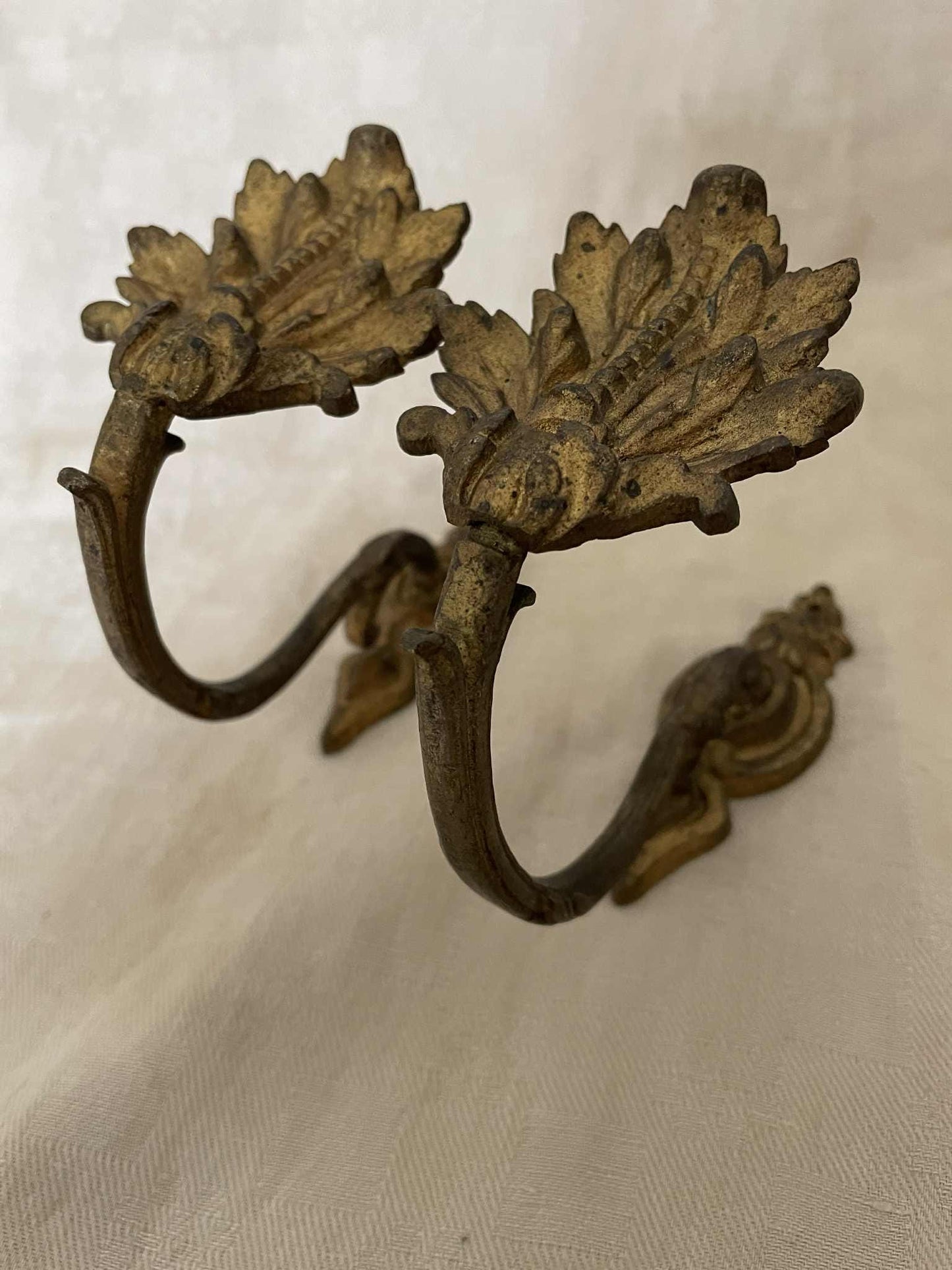 A pair of French gilded bronze curtain tie back/ wall hooks