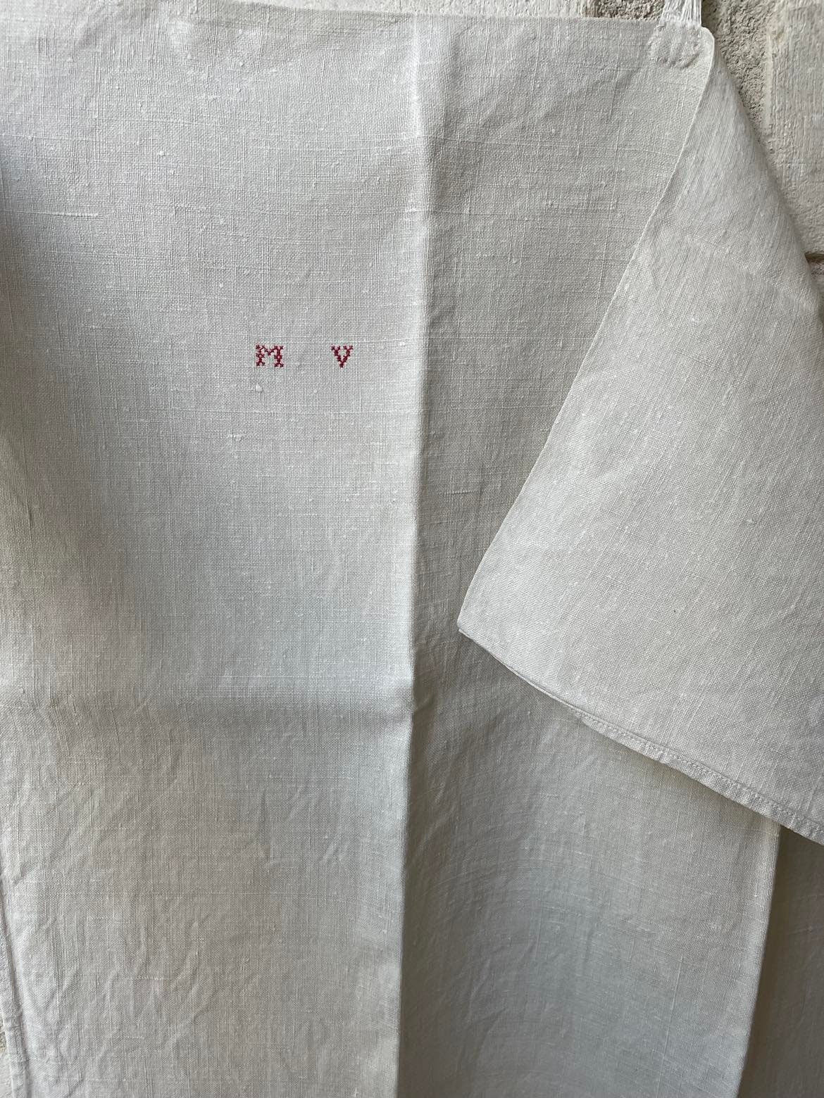 A single large plain Metis ( linen/cotton mix) tea towel initalled MV 100 x 52 cm
