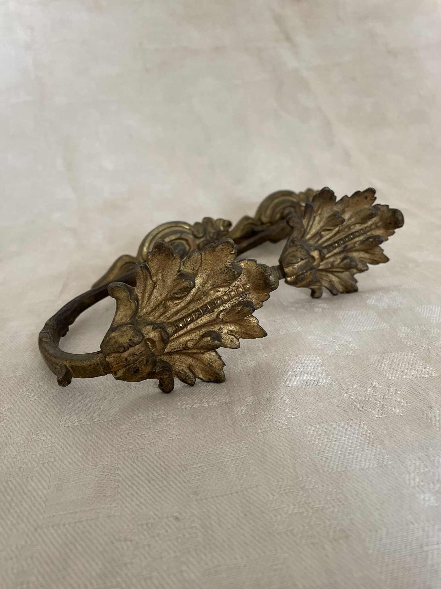 A pair of French gilded bronze curtain tie back/ wall hooks