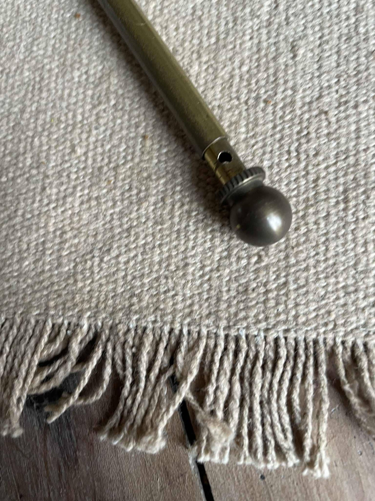 A single extendable brass lightweight curtain rod 58cm to 80cm max 7mm diameter