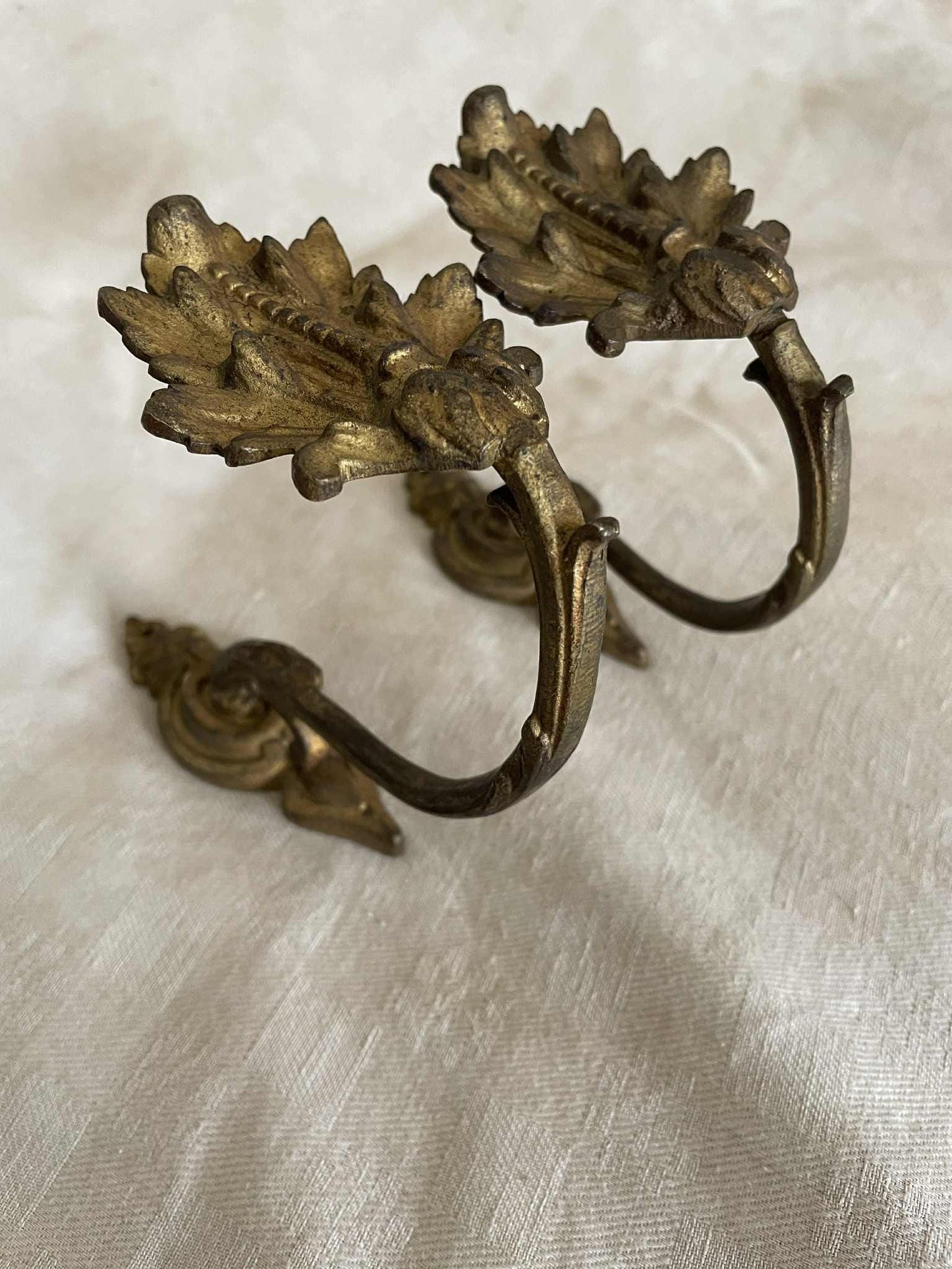 A pair of French gilded bronze curtain tie back/ wall hooks