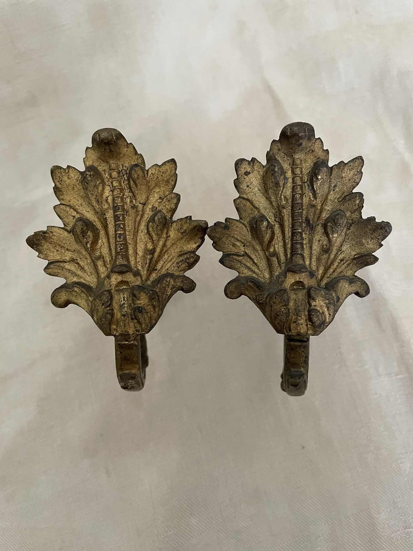 A pair of French gilded bronze curtain tie back/ wall hooks